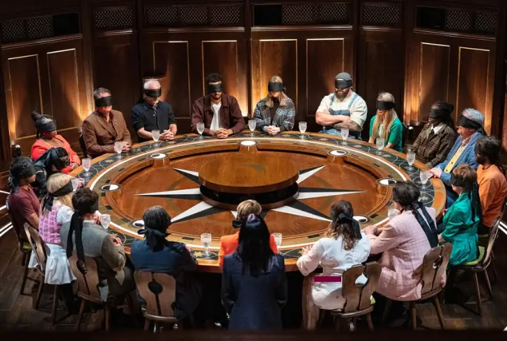 Blindfolded contestants round table