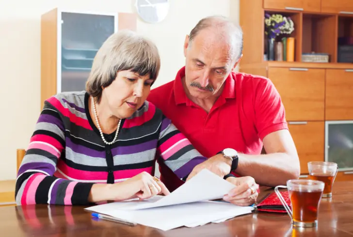 Elderly couple reviewing financial documents